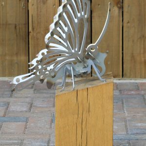 silver-metal-buttefly-on-wooden-stand